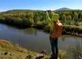 Hiker taking photo with smartphone at the riverside mountain Royalty Free Stock Photo