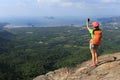 Woman hiker taking picture with smartphone Royalty Free Stock Photo