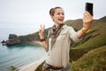 Woman hiker taking selfie with digital camera and showing victor Royalty Free Stock Photo