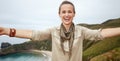 Woman hiker taking selfie in front of ocean view landscape Royalty Free Stock Photo