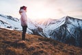 Woman hiker on a top of a mountains. First sun lights rise. Hiker relaxing in the mountain and enjoying sun. Backpack freedom conc Royalty Free Stock Photo