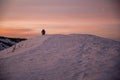 Woman hiker on a top of a mountains. First sun lights rise. Hiker relaxing in the mountain and enjoying sun. Backpack freedom conc Royalty Free Stock Photo