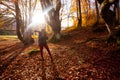 The woman hiker travels in the woods is looking around Royalty Free Stock Photo