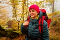 The woman hiker travels in the woods is looking around Royalty Free Stock Photo