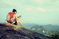 Woman hiker use digital tablet at mountain Royalty Free Stock Photo