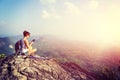 Woman hiker use digital tablet at mountain peak Royalty Free Stock Photo