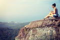 Woman hiker use digital tablet at mountain peak Royalty Free Stock Photo