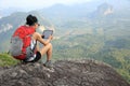Woman hiker use digital tablet at mountain peak Royalty Free Stock Photo