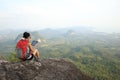 Woman hiker use digital tablet at mountain peak Royalty Free Stock Photo