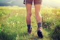 Woman hiker walking on trail in grassland Royalty Free Stock Photo