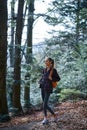 Woman hiker walking on the trail in the woods. Royalty Free Stock Photo