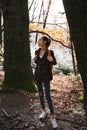 Woman hiker walking on the trail in the woods. Royalty Free Stock Photo