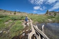 Woman hiker walks along the dirt trail in the 20 Lakes Basin hike in California Eastern Sierra Nevada mountains in the summer. Royalty Free Stock Photo