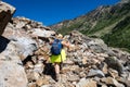 Woman hiker wearing a backpack and using trekking poles makes her way across scree along the Lake Solitude trail in Grand Teton Royalty Free Stock Photo