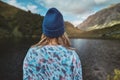 Woman hiker wearing winter hat enjoying lake view