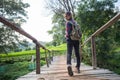 Woman hikers shoes. Female tourists walk along the bridge over the river