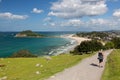 Woman hikes The Mount at Tauranga in NZ