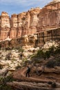 Woman Hikes Up A Dirt Trail With Hoodoos In The Distance Royalty Free Stock Photo