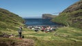 Woman hikes at the village of TjÃ¶rnuviÂ­k on Streymoy on the Faroe Islands during the day