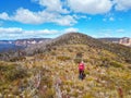 Woman hiking across an exposed hill high in the upper Blue Mountains Royalty Free Stock Photo