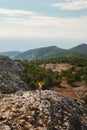 Woman hiking alone travel lifestyle tourist raised hands in mountains outdoor active vacations in Greece Royalty Free Stock Photo