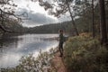 Woman hiking in the forest at lake in Tiveden National Park in Sweden