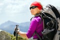 Woman hiking with backpack in mountains