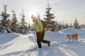 Woman hiking with dog in winter Royalty Free Stock Photo