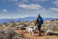 Woman hiking with her dog in the scenic rocky Mountains.