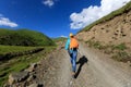 Woman hiking on high altitude mountain trail Royalty Free Stock Photo