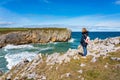 Woman hiking high on the cliffs of northern Spain, Asturias.