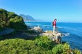 Woman hiking and looking at beautiful ocean view Royalty Free Stock Photo