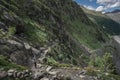 Woman hiking at Morteratsch Glacier in the Engadin in the Swiss Alps in summer with blue sky and sun