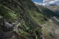 Woman hiking at Morteratsch Glacier in the Engadin in the Swiss Alps in summer with blue sky and sun