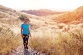 Woman hiking at a mountain during summer season. Healthy lifestyle. Sportswoman exercising, walking through nature path ascending Royalty Free Stock Photo