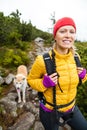 Woman hiking in mountains with akita dog