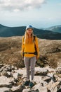 Woman hiking in mountains alone travel outdoor healthy lifestyle active summer vacations