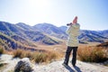 Woman hiking in mountains with camera. Royalty Free Stock Photo