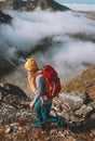 Woman hiking in mountains with red backpack travel trail running activity Royalty Free Stock Photo