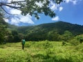 Woman hiking through an open field