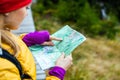 Woman hiking and reading map in forest Royalty Free Stock Photo