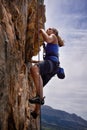 Woman, hiking and rock climbing for workout in outdoors, challenge and rope for training. Female person, cliff and Royalty Free Stock Photo