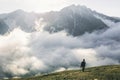 Woman hiking at sunset mountains with heavy backpack Travel Royalty Free Stock Photo