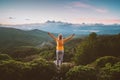 Woman hiking in sunset mountains outdoor travel lifestyle girl raised hands alone Royalty Free Stock Photo