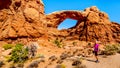 Woman on a Hiking Trail to the South Window Arch in the Windows Section in the desert landscape of Arches National Park Royalty Free Stock Photo