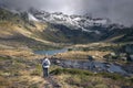 Woman hiking the tranquil trails at Tristaina Lakes, Andorra