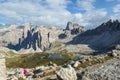 Woman hiking with the view on small, navy blue lakes at the bottom of the valley in Italian Alps. Royalty Free Stock Photo