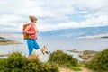 Woman hiking walking with dog on seaside trail Royalty Free Stock Photo