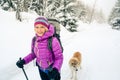 Happy woman walking in winter forest with dog Royalty Free Stock Photo