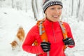 Woman hiking in winter with dog Royalty Free Stock Photo